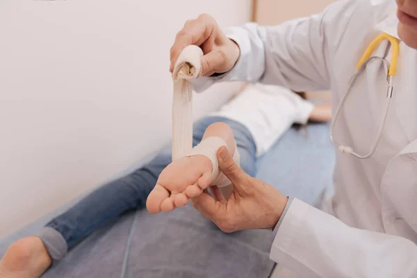 Precise attentive rheumatologist employing elastic bondage — Stock Photo, Image