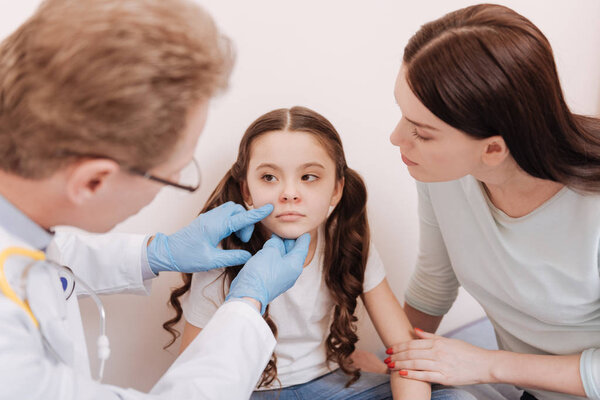 Worried ladies having consultation with dermatologist
