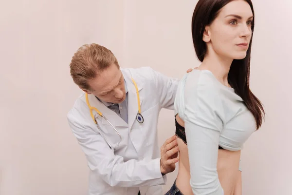 Graceful young woman having her spine checked — Stock Photo, Image