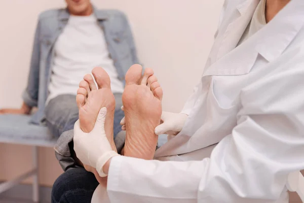 Trained competent specialist checking patients soles — Stock Photo, Image