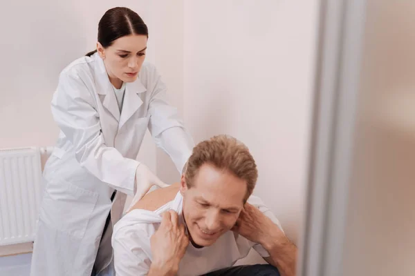 Scrupulous competent doctor seeing the cause of backache — Stock Photo, Image