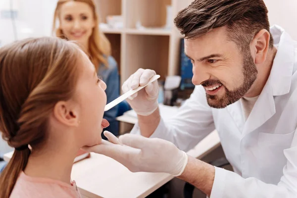 Positive delighted bearded professional checking throat — Stock Photo, Image