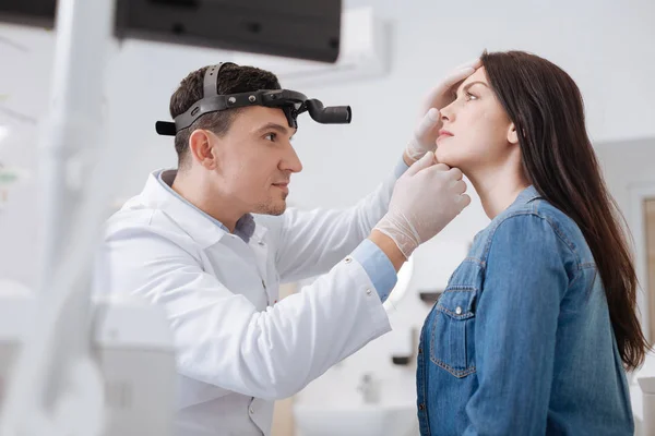 Portrait of otolaryngologist while working with patient — Stock Photo, Image