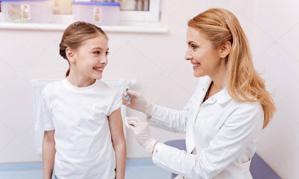 Smiling girl looking at her family doctor