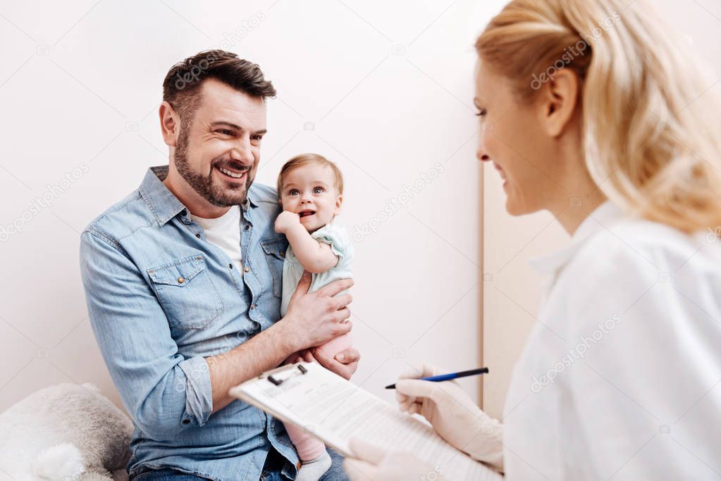 Smiling man looking at pediatrician