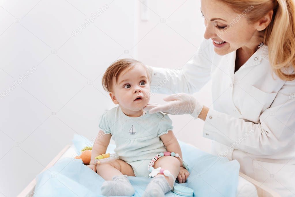Smiling doctor doing child examination
