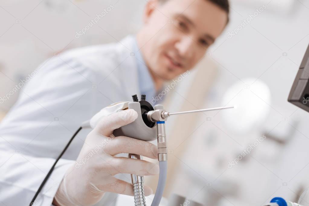 Close up of medical instrument being in male hand