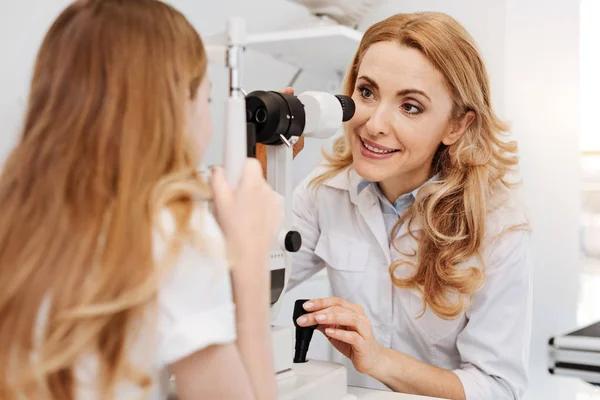 Vänliga ögonläkare förklarar hur utrustningen fungerar — Stockfoto