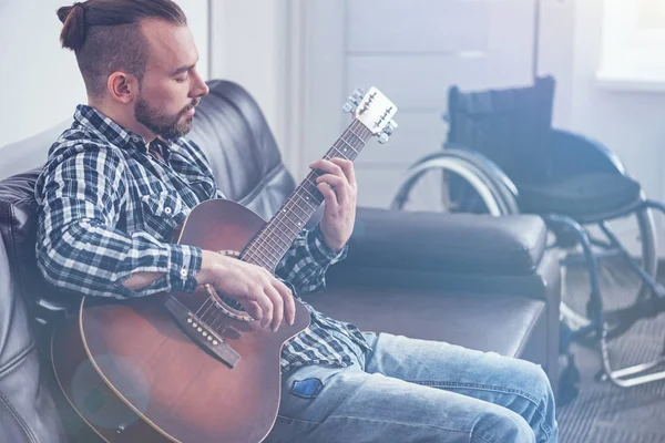 Skilled young handicap playing guitar indoors — Stock Photo, Image