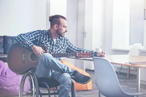 Involved creative young handicap creating a song at home — Stock Photo, Image