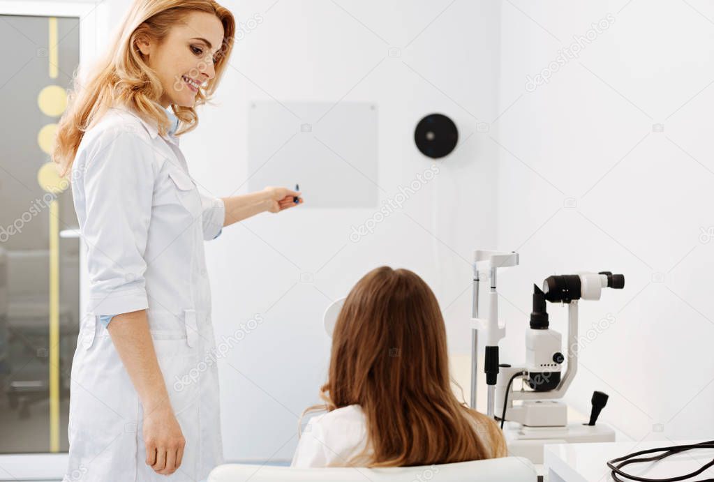 Lovely friendly ophthalmologist conducting an eyesight test
