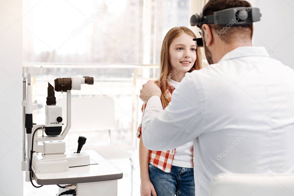 Lovely obedient child looking straight at the doctor