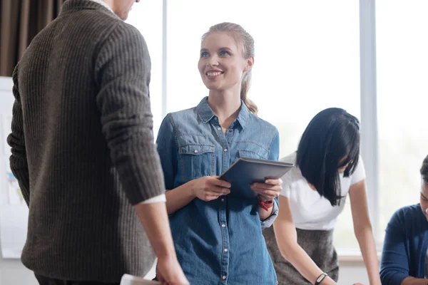 Nice happy woman standing near her colleague — Stock Photo, Image
