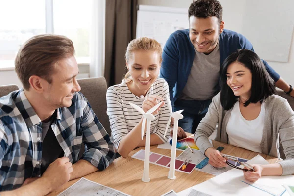 Beautiful curious woman looking at the windmill models — Stock Photo, Image