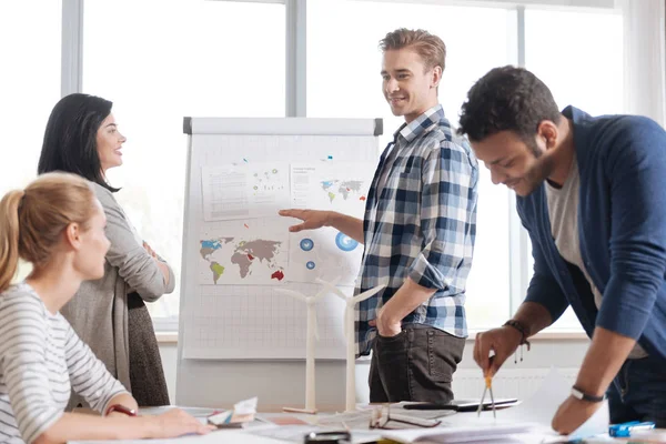 Joyful pleasant man explaining the strategy to his colleagues — Stock Photo, Image