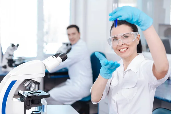 Beautiful brunette demonstrating new chemical agent — Stock Photo, Image