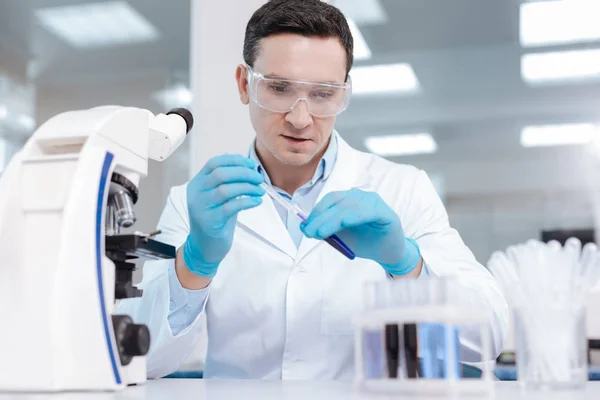 Attentive male person taking chemical agent — Stock Photo, Image