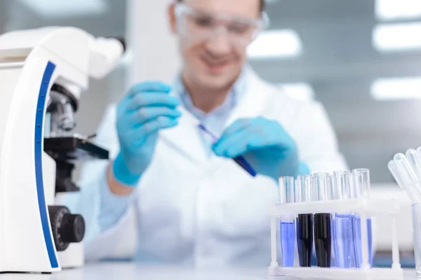 Close up of test glasses being full blue liquid — Stock Photo, Image