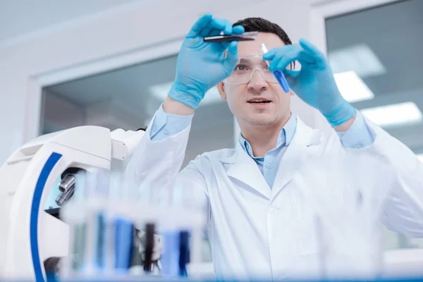 Attentive scientist wearing protective glasses — Stock Photo, Image