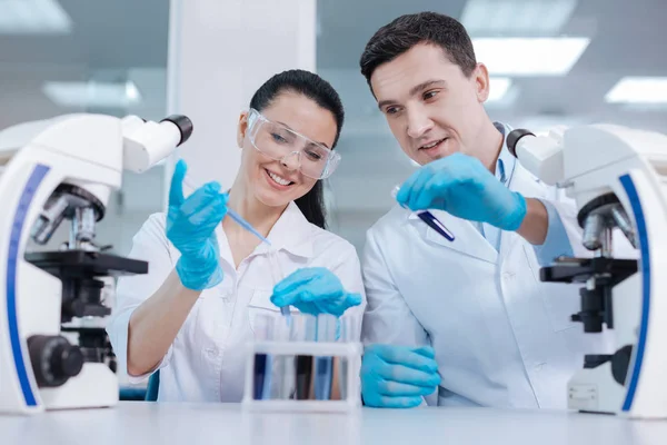 Positive delighted female working in laboratory