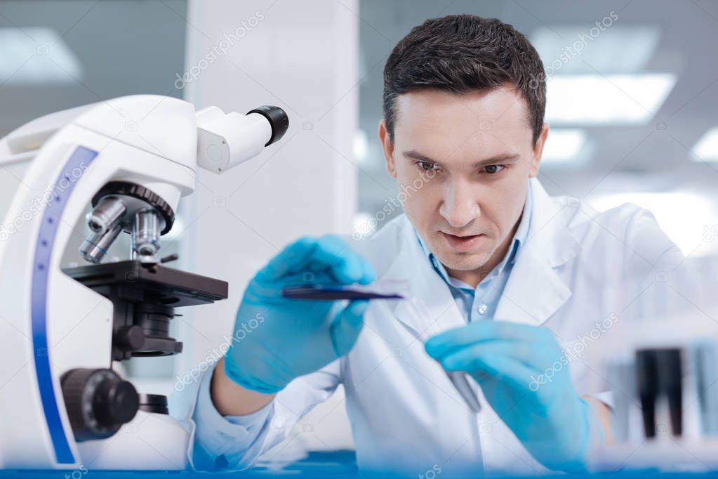 Handsome medical worker examining chemical agent