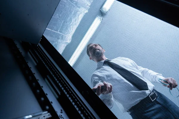 Serious handsome technician checking the network server — Stock Photo, Image