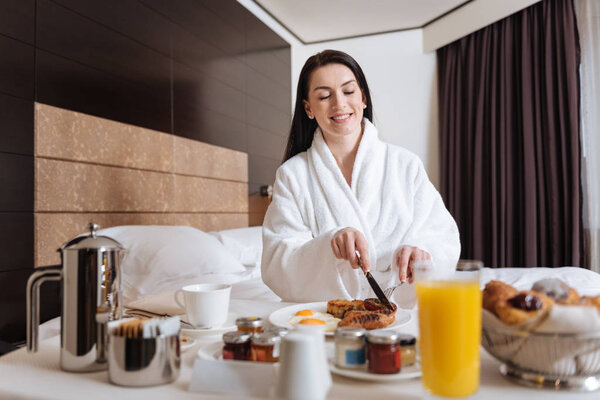 Joyful happy woman holding a knife