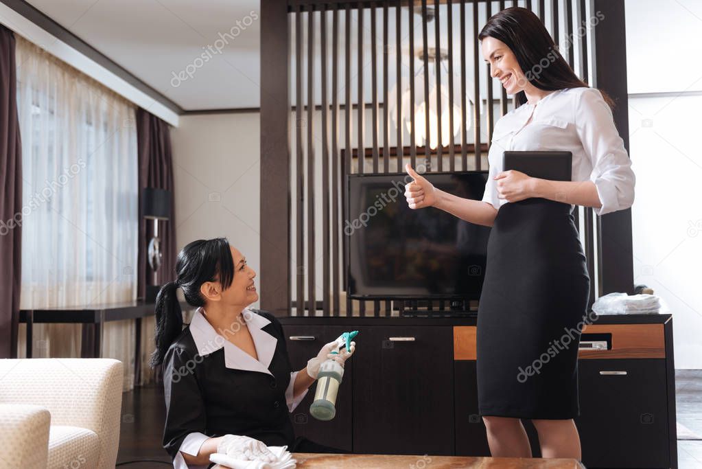 Happy delighted manager being satisfied with her maids work