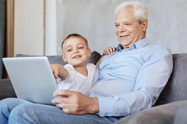 Optimistisches charismatisches Kind lehrt seinen Opa — Stockfoto
