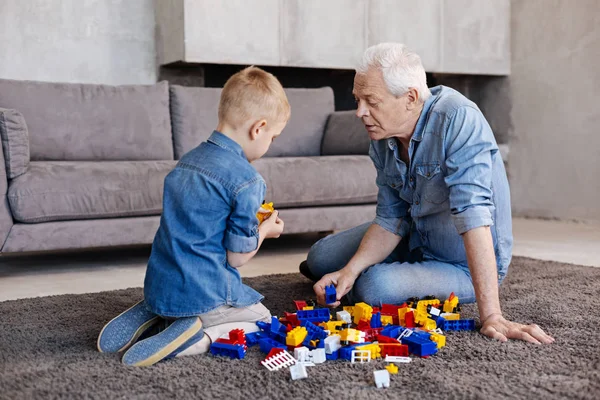 Encantador menino curioso mostrando algo para seu avô — Fotografia de Stock