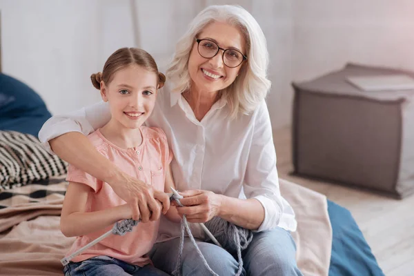 Joyful cheerful girl knitting — Stock Photo, Image