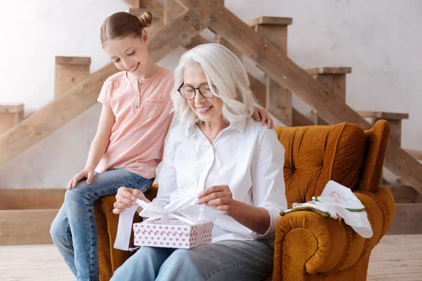 Happy good looking woman opening a present box — Stock Photo, Image