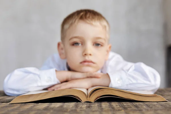 Κουρασμένο νεαρό αγόρι βαρεθεί ανάγνωση — Φωτογραφία Αρχείου