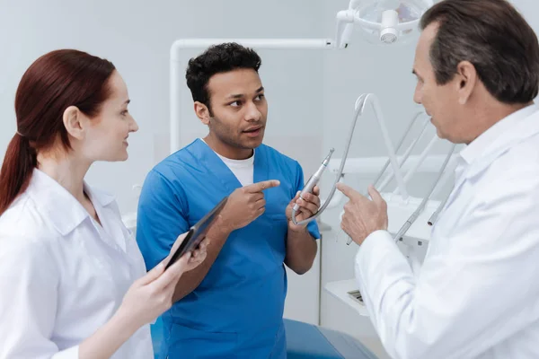Profile photo of dentist that pointing at tools for stomatologist — Stock Photo, Image