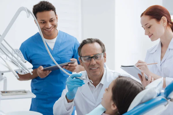 Smiling foreign intern keeping tablet in both hands — Stock Photo, Image