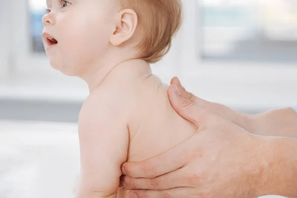 Experienced king careful pediatrician making massage — Stock Photo, Image