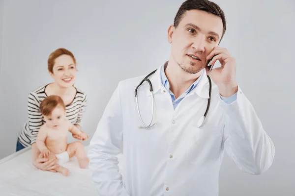 Worried qualified pediatrician talking to his colleague — Stock Photo, Image