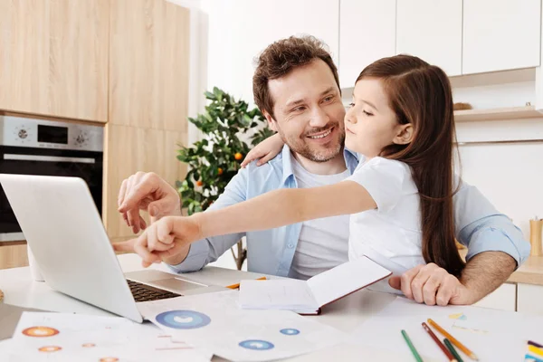 Hija y padre abrazando y señalando el portátil — Foto de Stock