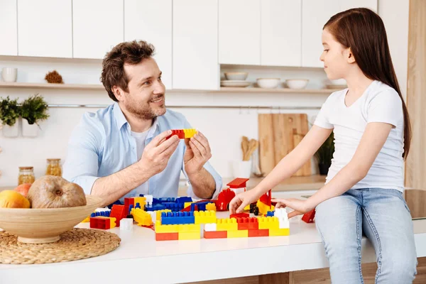 Father holding two construction set pieces together — Stock Photo, Image