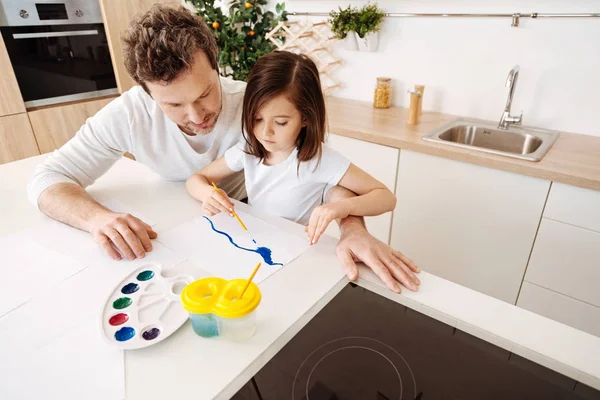 Young father being curious about his daughters picture — Stock Photo, Image