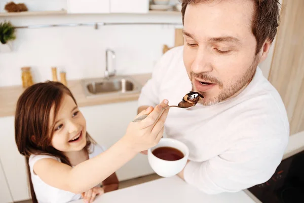 Loving daughter feeding her father — Stock Photo, Image