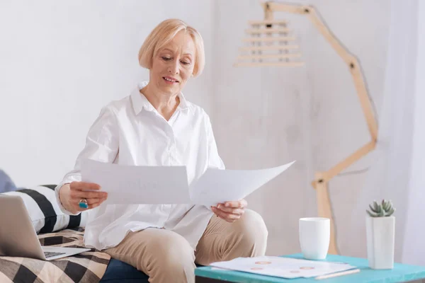 Atenta mujer de negocios senior que comprueba documentos — Foto de Stock