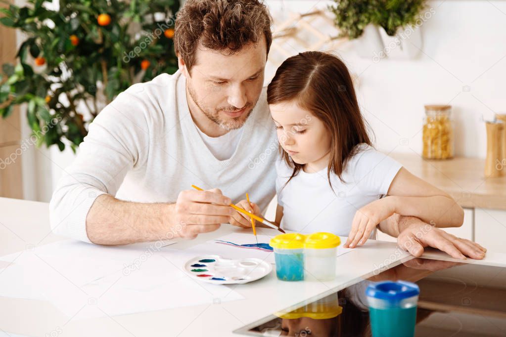 Loving father painting with his daughter