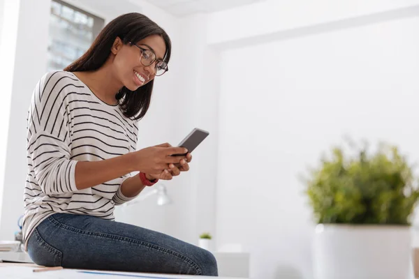 Delighted nice woman using a cell phone — Stock Photo, Image