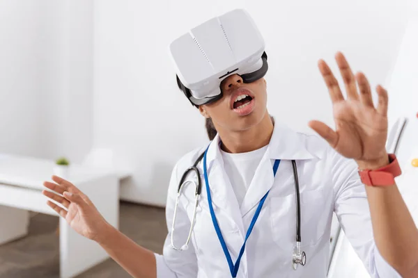 Pleasant young doctor being in 3d reality — Stock Photo, Image
