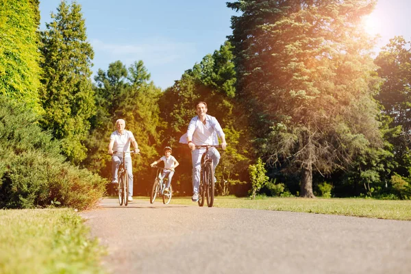 Optimistisch actieve familie maken hun weg door het park — Stockfoto