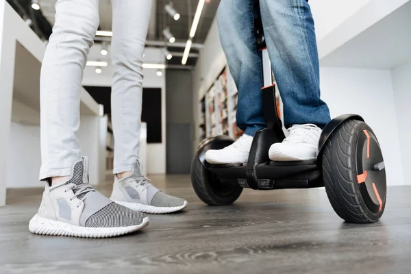 Scaled up shot of man standing on self balancing scooter — Stock Photo, Image