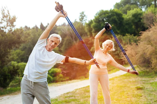 Joyful active people doing physical exercises — Stock Photo, Image