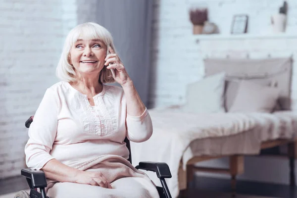 Senhora deficiente encantado usando telefone em casa — Fotografia de Stock