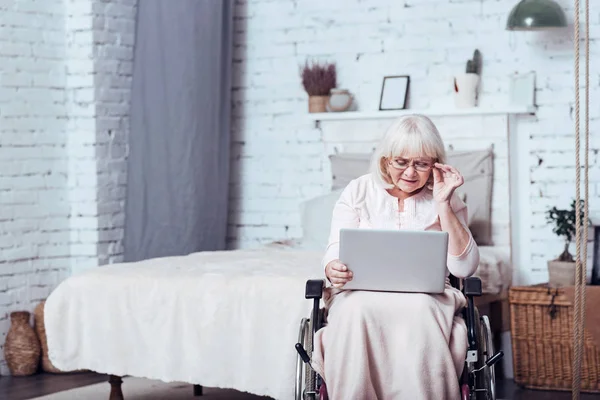 Donna handicappato coinvolto invecchiamento utilizzando il computer portatile a casa — Foto Stock